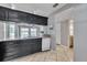 Well-lit kitchen with granite countertops, black cabinetry, and views of the lake at 8719 Lake Place Ln, Tampa, FL 33634