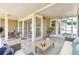 Inviting lanai area perfect for relaxation, featuring tile flooring, outdoor furniture, and access to the outdoors at 8719 Lake Place Ln, Tampa, FL 33634