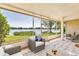 Relaxing lanai with screened enclosure, comfortable seating, and scenic views of the lake at 8719 Lake Place Ln, Tampa, FL 33634