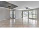 Spacious living room featuring tile flooring and large windows and sliding doors, filling the space with natural light at 8719 Lake Place Ln, Tampa, FL 33634