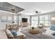 Bright living room with large windows, tile flooring, stylish decor, and a view of the outdoors at 8719 Lake Place Ln, Tampa, FL 33634