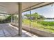 Screened patio featuring tiled floor and views of the lake and surrounding greenery at 8719 Lake Place Ln, Tampa, FL 33634