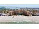 Aerial view of the beachfront highrise condo with pool and ocean access at 880 Mandalay Ave # C908, Clearwater Beach, FL 33767
