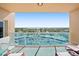 Inviting balcony features seating, a glass railing, and a panoramic view of the city skyline and ocean at 880 Mandalay Ave # C908, Clearwater Beach, FL 33767