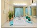 Bright bathroom features a wide mirror, vanity, and coastal-themed decorations at 880 Mandalay Ave # C908, Clearwater Beach, FL 33767
