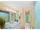 Charming bathroom featuring vanity, mirror, and colorful, beach-themed decor at 880 Mandalay Ave # C908, Clearwater Beach, FL 33767