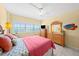 Bright bedroom with tile flooring, dresser, and a window view at 880 Mandalay Ave # C908, Clearwater Beach, FL 33767