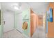 Bright hallway features ample closet space, neutral tile flooring, and beach-themed decor at 880 Mandalay Ave # C908, Clearwater Beach, FL 33767