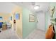 Bright hallway with tile floors and coastal décor leads to the kitchen and living areas at 880 Mandalay Ave # C908, Clearwater Beach, FL 33767