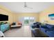 Inviting living room features comfortable seating, ceiling fan, and balcony with ocean views at 880 Mandalay Ave # C908, Clearwater Beach, FL 33767