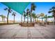 Outdoor grilling area with multiple grills, seating, tables and palm trees, perfect for dining at 880 Mandalay Ave # C908, Clearwater Beach, FL 33767