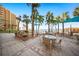 Outdoor dining area featuring grills, tables, and seating, perfect for entertaining with an ocean view at 880 Mandalay Ave # C908, Clearwater Beach, FL 33767