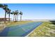 Shuffleboard court with ocean backdrop and palm trees, providing a relaxing outdoor activity at 880 Mandalay Ave # C908, Clearwater Beach, FL 33767