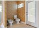 Powder room showcasing a bidet, toilet, and access to the outdoors at 8933 Crescent Forest Blvd, New Port Richey, FL 34654