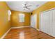 Bright bedroom with hardwood floors, ceiling fan and large windows at 8933 Crescent Forest Blvd, New Port Richey, FL 34654