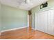 Neutral bedroom featuring wood floors, closet and fan at 8933 Crescent Forest Blvd, New Port Richey, FL 34654