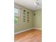 Comfortable bedroom with wood floors, window and decorative wall art at 8933 Crescent Forest Blvd, New Port Richey, FL 34654