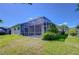 Enjoy the outdoors in this backyard with a screened lanai and green lawn, offering privacy and space at 9211 Everwood Ct, Tampa, FL 33647