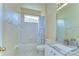 Well-lit bathroom features a shower-tub combo, granite countertops, and tile flooring at 9211 Everwood Ct, Tampa, FL 33647
