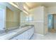 Bathroom with double vanity, granite countertops and marble floors at 9211 Everwood Ct, Tampa, FL 33647