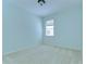 Well-lit bedroom with a window, neutral carpeting and a fresh interior at 9211 Everwood Ct, Tampa, FL 33647