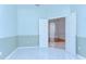 Bedroom with tile floors and two-tone walls with a view through an open doorway at 9211 Everwood Ct, Tampa, FL 33647