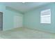 Bedroom features carpet, double door closet, and natural light at 9211 Everwood Ct, Tampa, FL 33647