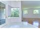 Breakfast nook with large windows, tile flooring, and a view of the backyard at 9211 Everwood Ct, Tampa, FL 33647