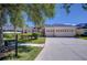 Attractive home featuring an attached three car garage, front lawn with trimmed hedges, and a stone accented entryway at 9211 Everwood Ct, Tampa, FL 33647