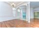 Bright foyer with wood floors, white columns, arched doorway, and elegant chandelier at 9211 Everwood Ct, Tampa, FL 33647
