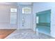 Bright foyer features a marble tile transitioning to wood flooring, a decorative front door, and a view of another room at 9211 Everwood Ct, Tampa, FL 33647