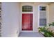 Red front door with decorative glass at 9211 Everwood Ct, Tampa, FL 33647