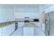 Kitchen with white cabinetry, granite countertops, stainless steel appliances and central island at 9211 Everwood Ct, Tampa, FL 33647