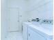 Well-lit laundry room with washer, dryer, and ample storage space at 9211 Everwood Ct, Tampa, FL 33647