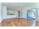 Open living room with hardwood floors, access to lanai and view of kitchen at 9211 Everwood Ct, Tampa, FL 33647