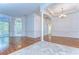 Spacious room with wood and tile flooring, complemented by elegant columns and access to other rooms at 9211 Everwood Ct, Tampa, FL 33647