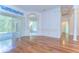 Bright living room featuring wood floors and sliding glass doors at 9211 Everwood Ct, Tampa, FL 33647