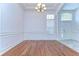 Open-concept living room with hardwood floors and paneled walls at 9211 Everwood Ct, Tampa, FL 33647