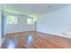 Bright living room featuring hardwood floors, arched windows, and neutral walls at 9211 Everwood Ct, Tampa, FL 33647