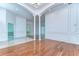 Spacious living room with wood floors, columns, and decorative wall panels at 9211 Everwood Ct, Tampa, FL 33647
