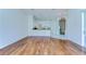 Open living room with hardwood floors and partial view of modern kitchen at 9211 Everwood Ct, Tampa, FL 33647
