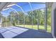 Spacious screened patio with backyard view and access to the lawn at 9211 Everwood Ct, Tampa, FL 33647