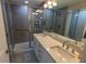 Bathroom featuring dual sinks, framed mirror, and glass enclosed shower at 9660 Sweetwell Pl, Riverview, FL 33569
