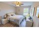 Comfortable bedroom with hardwood floors, lots of natural light, and ceiling fan at 9660 Sweetwell Pl, Riverview, FL 33569