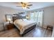 Comfortable bedroom with hardwood floors, lots of natural light, and ceiling fan at 9660 Sweetwell Pl, Riverview, FL 33569