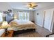Comfortable bedroom with hardwood floors, lots of natural light, and ceiling fan at 9660 Sweetwell Pl, Riverview, FL 33569