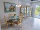 Dining area with an octagonal glass-top table set with blue plates and wooden chairs at 9660 Sweetwell Pl, Riverview, FL 33569