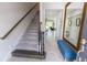 Welcoming foyer with stairs, wood-look tile flooring, and bench seating offers an inviting entrance at 9660 Sweetwell Pl, Riverview, FL 33569