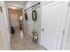 Inviting hallway with wood-look tile flooring, neutral walls, and stylish decorative accents enhance the home's appeal at 9660 Sweetwell Pl, Riverview, FL 33569