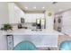 Stylish kitchen boasts white cabinets, modern appliances, and a large countertop at 9660 Sweetwell Pl, Riverview, FL 33569